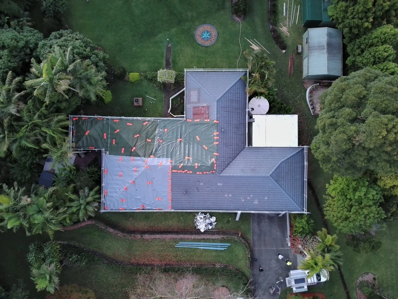 Roof tarped with PVC tarps to stop leaks during roof replacement